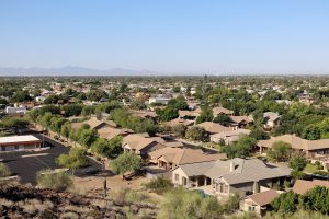 Roofing contractor inspecting tile roof underlayment in Arizona